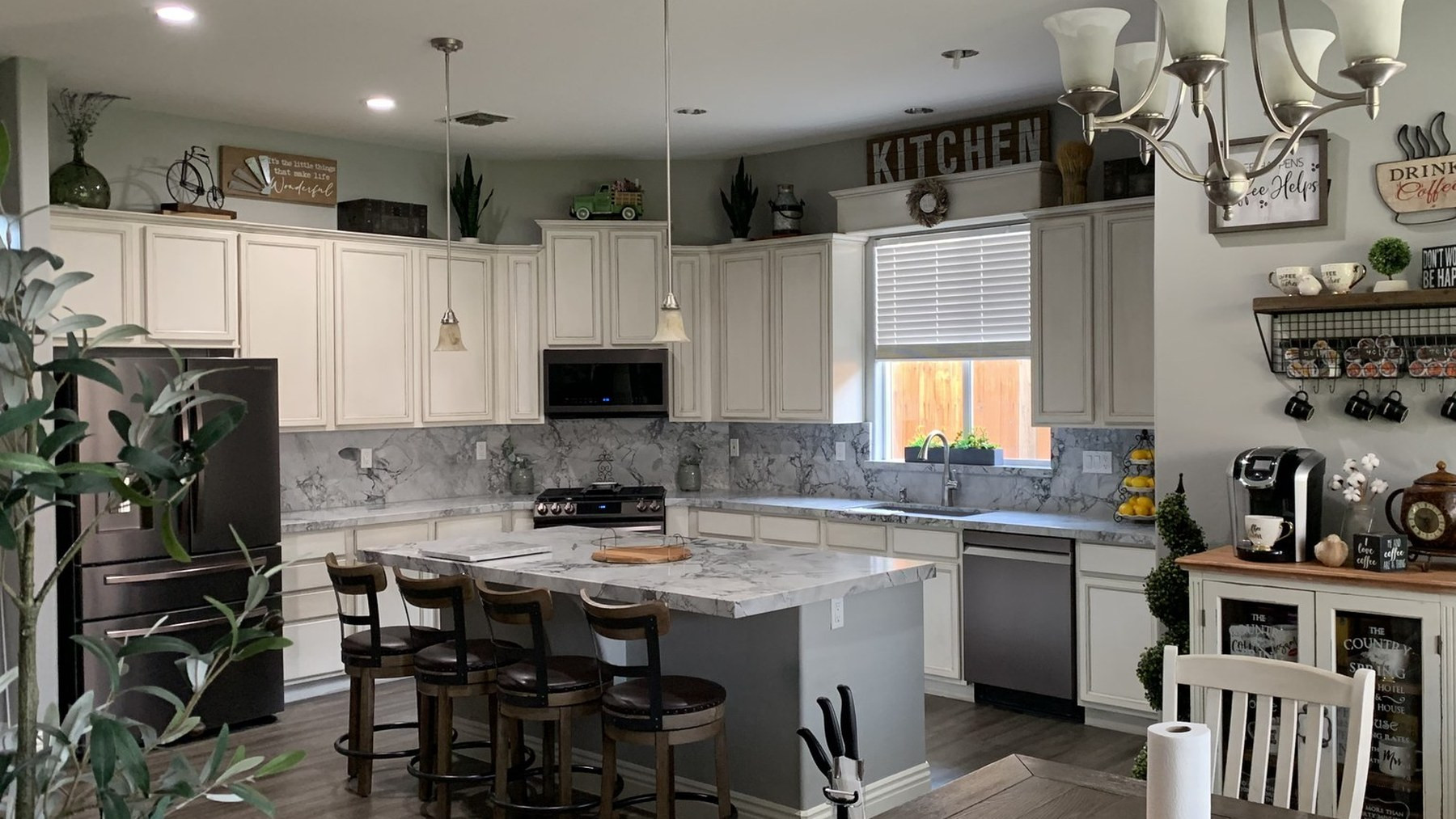 Kitchen after — quartz countertops and full slab backsplash