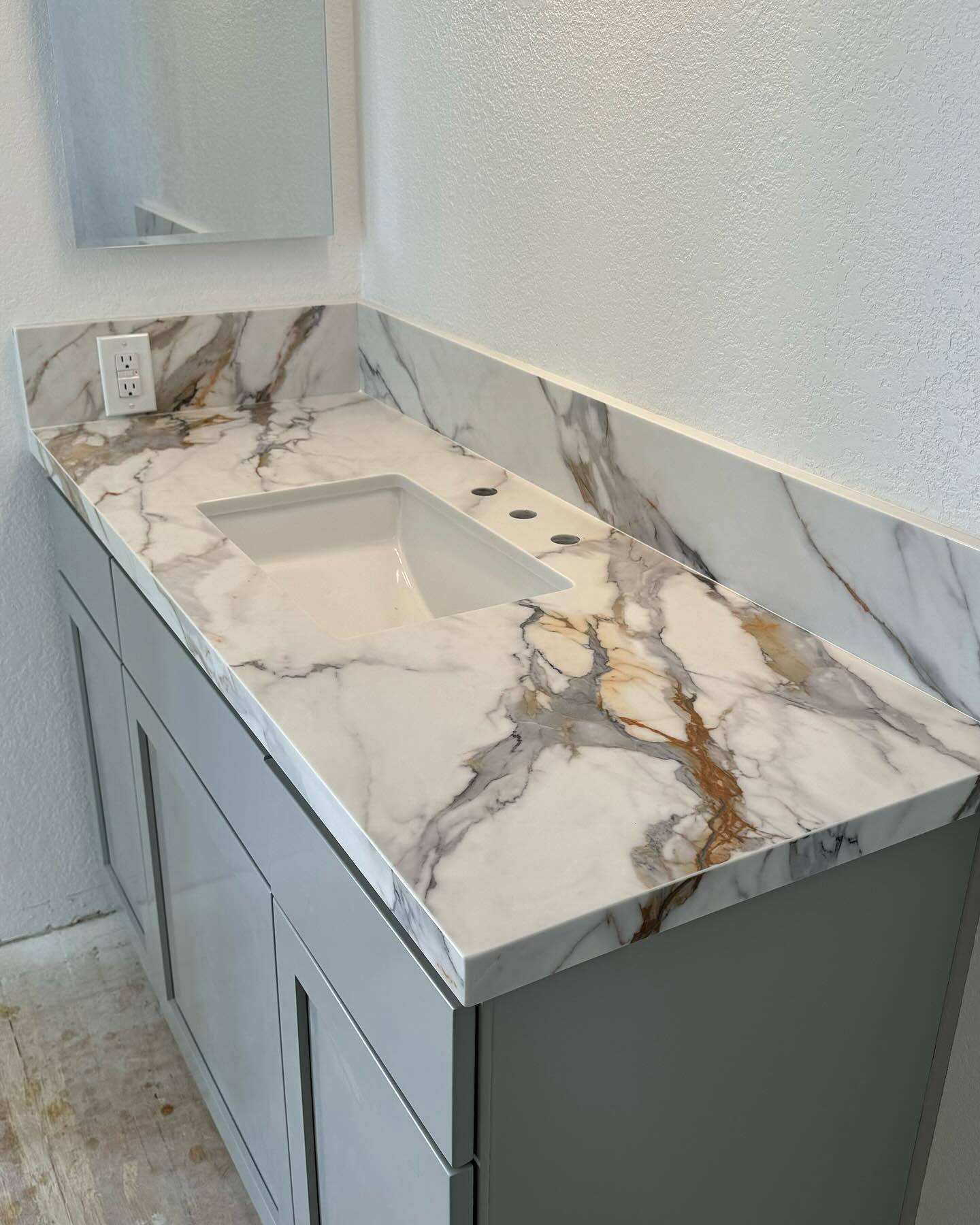 Calacatta Gold vanity top with matching backsplash