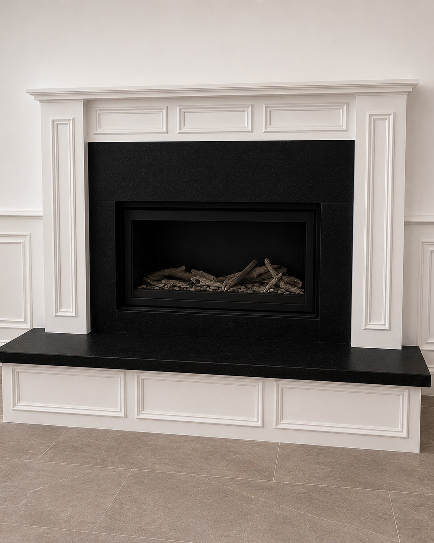Black granite fireplace surround and hearth with white mantel