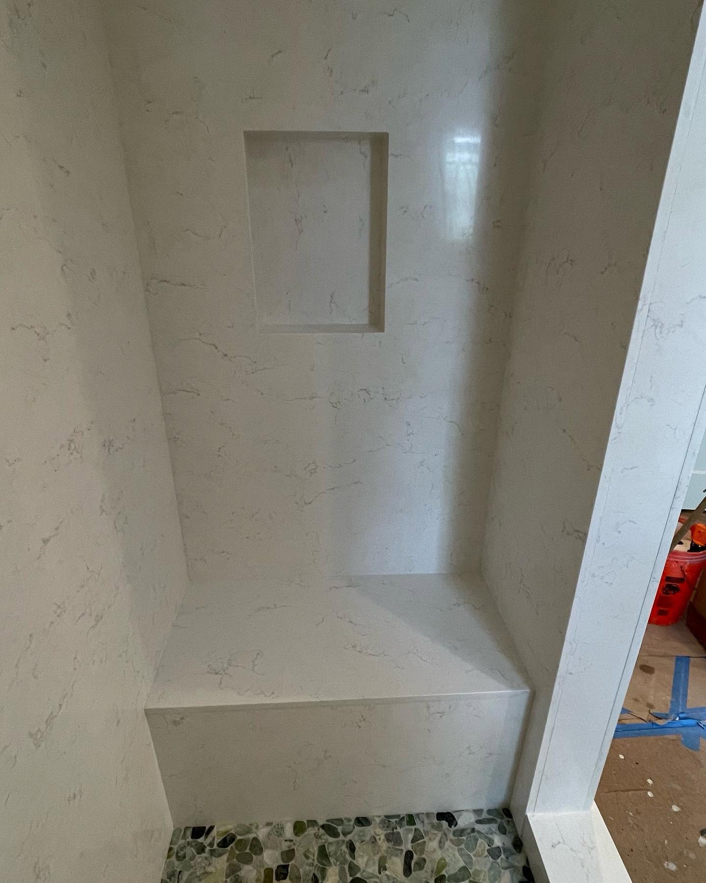 Quartz shower walls with built-in bench and niche